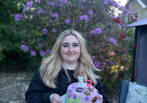 Charlotte holding cake